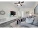 Spacious living room with new gray wood-look flooring, ceiling fan, and neutral décor at 1561 S Martin Luther King Jr Ave, Clearwater, FL 33756