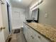 Contemporary bathroom features a granite countertop, modern fixtures, and a walk-in shower at 1619 E Nome St, Tampa, FL 33604