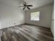 Bright bedroom features hardwood floors and a large window providing natural light at 1619 E Nome St, Tampa, FL 33604