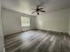 Bedroom with new flooring, window, and ceiling fan at 1619 E Nome St, Tampa, FL 33604