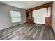 Cozy bedroom with hardwood floors, paneled walls, and a bright window with natural light at 1619 E Nome St, Tampa, FL 33604