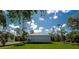 Well-manicured backyard with lush grass and blue skies at 163 Swift St, Port Charlotte, FL 33954