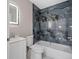 Bathroom featuring modern gray and black tiling and a vanity with a lighted mirror at 163 Swift St, Port Charlotte, FL 33954