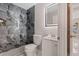 Bathroom featuring modern, stylish gray and black tiling, vanity, and a unique LED mirror at 163 Swift St, Port Charlotte, FL 33954
