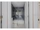 Bathroom with modern gray tiling, white fixtures, and open doorway at 163 Swift St, Port Charlotte, FL 33954