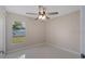 Bedroom with a ceiling fan, neutral walls, and a window that allows natural light at 163 Swift St, Port Charlotte, FL 33954