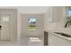 Bright kitchen featuring white cabinets, modern countertops and sink, and natural light at 163 Swift St, Port Charlotte, FL 33954