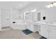 Bathroom featuring double sinks, soaking tub, and separate glass shower at 17415 Holly Well Ave, Wimauma, FL 33598