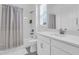 Bathroom featuring a shower-tub combo and vanity with ample storage at 17415 Holly Well Ave, Wimauma, FL 33598