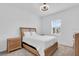 Bedroom with a queen-sized bed and two nightstands with wood accents at 17415 Holly Well Ave, Wimauma, FL 33598