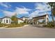 Exterior view of the clubhouse featuring manicured landscaping and a covered entryway at 17415 Holly Well Ave, Wimauma, FL 33598