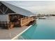 Exterior of the clubhouse with a scenic view of the water and deck space at 17415 Holly Well Ave, Wimauma, FL 33598