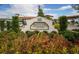 Medley Clubhouse sign with lush landscaping in front at 17415 Holly Well Ave, Wimauma, FL 33598