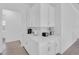 Stylish white kitchen featuring ample countertop space, modern appliances, and sleek cabinetry at 17415 Holly Well Ave, Wimauma, FL 33598