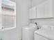 Bright laundry room with a front-loading washer and dryer at 17415 Holly Well Ave, Wimauma, FL 33598