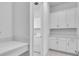 Laundry room with white cabinets, countertops, and modern appliances at 17415 Holly Well Ave, Wimauma, FL 33598