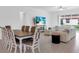Open-concept dining and living area with modern furniture and plenty of natural light at 17415 Holly Well Ave, Wimauma, FL 33598