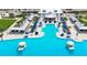 Aerial view of the community pool with lounge chairs and umbrellas on the pool deck at 17415 Holly Well Ave, Wimauma, FL 33598