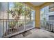 Enclosed outdoor balcony with trees and plants; relaxing space at 18001 Richmond Place Dr # 116, Tampa, FL 33647