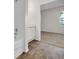 Bathroom featuring hardwood floors, white vanity, shower with door, and view to the carpeted bedroom at 18001 Richmond Place Dr # 116, Tampa, FL 33647