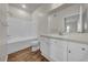 Bathroom featuring a shower over the tub and a vanity with storage at 18001 Richmond Place Dr # 116, Tampa, FL 33647