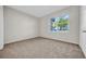 Cozy carpeted bedroom with a bright window and a closet provides a relaxing personal space at 18001 Richmond Place Dr # 116, Tampa, FL 33647