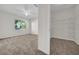 Inviting bedroom with carpet, closet, and a window, next to a walk-in closet at 18001 Richmond Place Dr # 116, Tampa, FL 33647