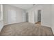 Spacious bedroom featuring three doors with carpeted floors and ample closet space at 18001 Richmond Place Dr # 116, Tampa, FL 33647