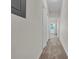 Hallway with carpeted floors and white doors leading to various rooms enhances privacy and functionality at 18001 Richmond Place Dr # 116, Tampa, FL 33647