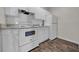 White appliances and cabinets give the kitchen a clean, modern look at 18001 Richmond Place Dr # 116, Tampa, FL 33647