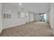 Large living room with neutral carpet and sliding glass doors to balcony at 18001 Richmond Place Dr # 116, Tampa, FL 33647