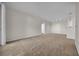 Bright, carpeted living room with neutral walls and recessed lighting provides a versatile living space at 18001 Richmond Place Dr # 116, Tampa, FL 33647