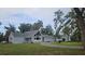 Charming home boasts a well-maintained yard, mature trees, complementing the property's inviting exterior and curb appeal at 21451 Us Highway 98, Dade City, FL 33523