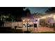 Well-lit backyard patio with seating, outdoor kitchen, and landscaped garden area perfect for entertaining at 3212 Stevenson St, Plant City, FL 33566