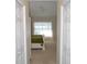 Hallway view into a bedroom with a bed, sheer curtains, and white wooden furniture at 3212 Stevenson St, Plant City, FL 33566