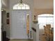 Bright entryway with a white front door, transom window, and view into the dining room at 3212 Stevenson St, Plant City, FL 33566