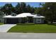 Charming single-story home featuring a metal roof, well-manicured lawn, and two-car garage at 3212 Stevenson St, Plant City, FL 33566