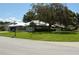 Pleasant home exterior featuring a well-manicured lawn and established trees in a tranquil neighborhood at 3212 Stevenson St, Plant City, FL 33566