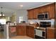 Spacious kitchen featuring stainless steel appliances, a large sink, and dark wood cabinets at 3212 Stevenson St, Plant City, FL 33566