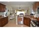 Well-lit kitchen with dark wood cabinetry, stainless steel appliances, and adjoining breakfast nook at 3212 Stevenson St, Plant City, FL 33566