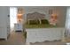 Cozy bedroom with white wooden furniture, a comfortable upholstered headboard, and soft green accents at 3212 Stevenson St, Plant City, FL 33566