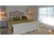 Bright bedroom with a bed, white wooden furniture, and soft natural light from a sheer-curtained window at 3212 Stevenson St, Plant City, FL 33566