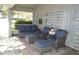 Screened patio features comfortable wicker seating with blue cushions and an inviting atmosphere at 3212 Stevenson St, Plant City, FL 33566