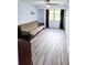 Light filled bedroom with a futon, wood look floors, and a ceiling fan at 3315 58Th S Ave # 115, St Petersburg, FL 33712