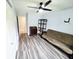 Bedroom features wood look floors, closet and futon at 3315 58Th S Ave # 115, St Petersburg, FL 33712