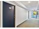Hallway featuring a blue door and carpeted floor at 3315 58Th S Ave # 115, St Petersburg, FL 33712