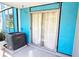 Outdoor patio featuring a Goodman AC unit, blue siding, and sliding glass doors at 3315 58Th S Ave # 115, St Petersburg, FL 33712