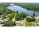 Aerial view of property with mature trees close to large lake at 4018 E Bluff Ave, Tampa, FL 33617
