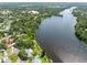 Aerial view of property close to large lake surrounded by mature trees at 4018 E Bluff Ave, Tampa, FL 33617