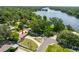 Aerial view of home near a lake featuring a large lot and mature trees at 4018 E Bluff Ave, Tampa, FL 33617